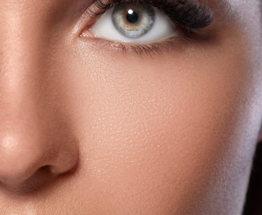 Female face with beautiful eyebrows and artificial eyelashes for maximum volume