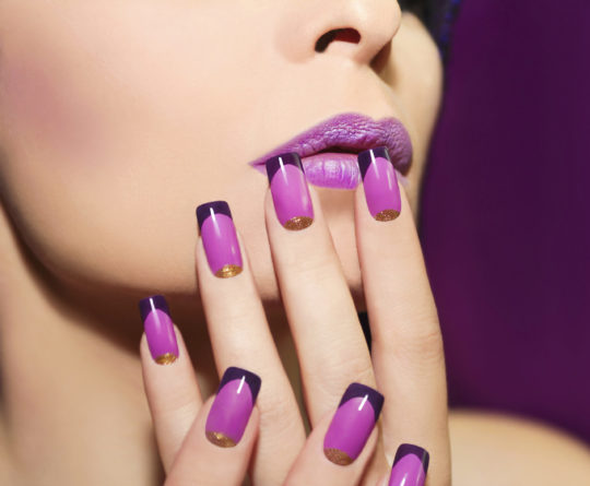 Lilac French manicure for a young woman with purple lips.