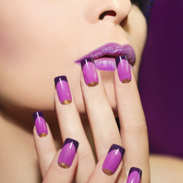 Lilac French manicure for a young woman with purple lips.