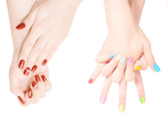 Woman hands with colored nail polish set in the row. Isolated on white