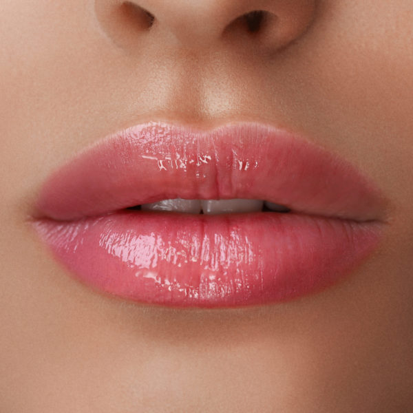 Healthy Spa: Young Beautiful Woman Having Permanent Make-up (Tattoo) on her Lips. Close-up