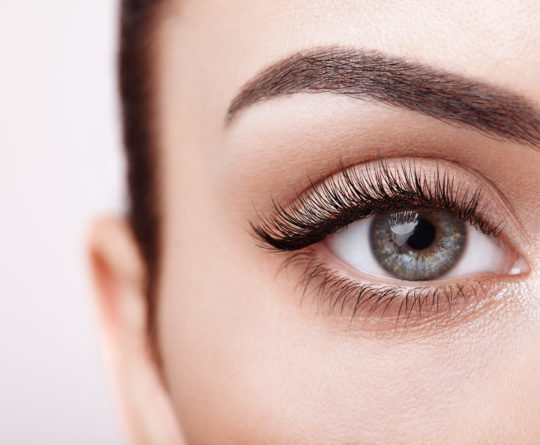 Female Eye with Extreme Long False Eyelashes. Eyelash Extensions. Makeup, Cosmetics, Beauty. Close up, Macro