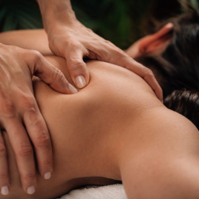 Woman Enjoying Deep Tissue Massage in Salon