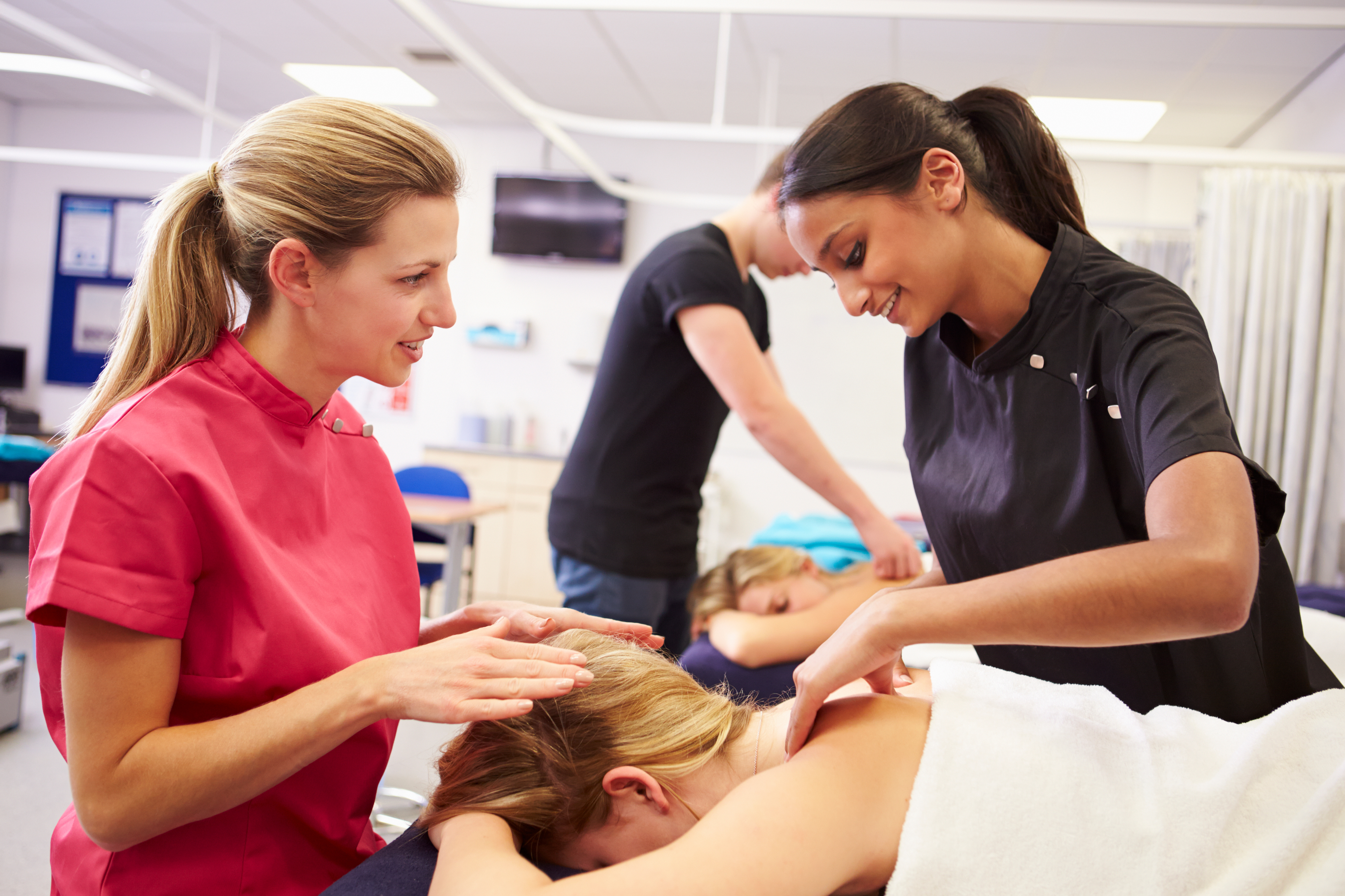 Teacher Helping Student Training To Become Masseuse AdobeStock 84479535